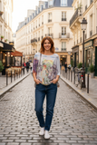 Woman wearing Paris Bike Top in a charming Paris street, showcasing elegant style and whimsical bike design.