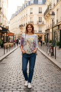 Woman wearing Paris Bike Top in a charming Paris street, showcasing elegant style and whimsical bike design.