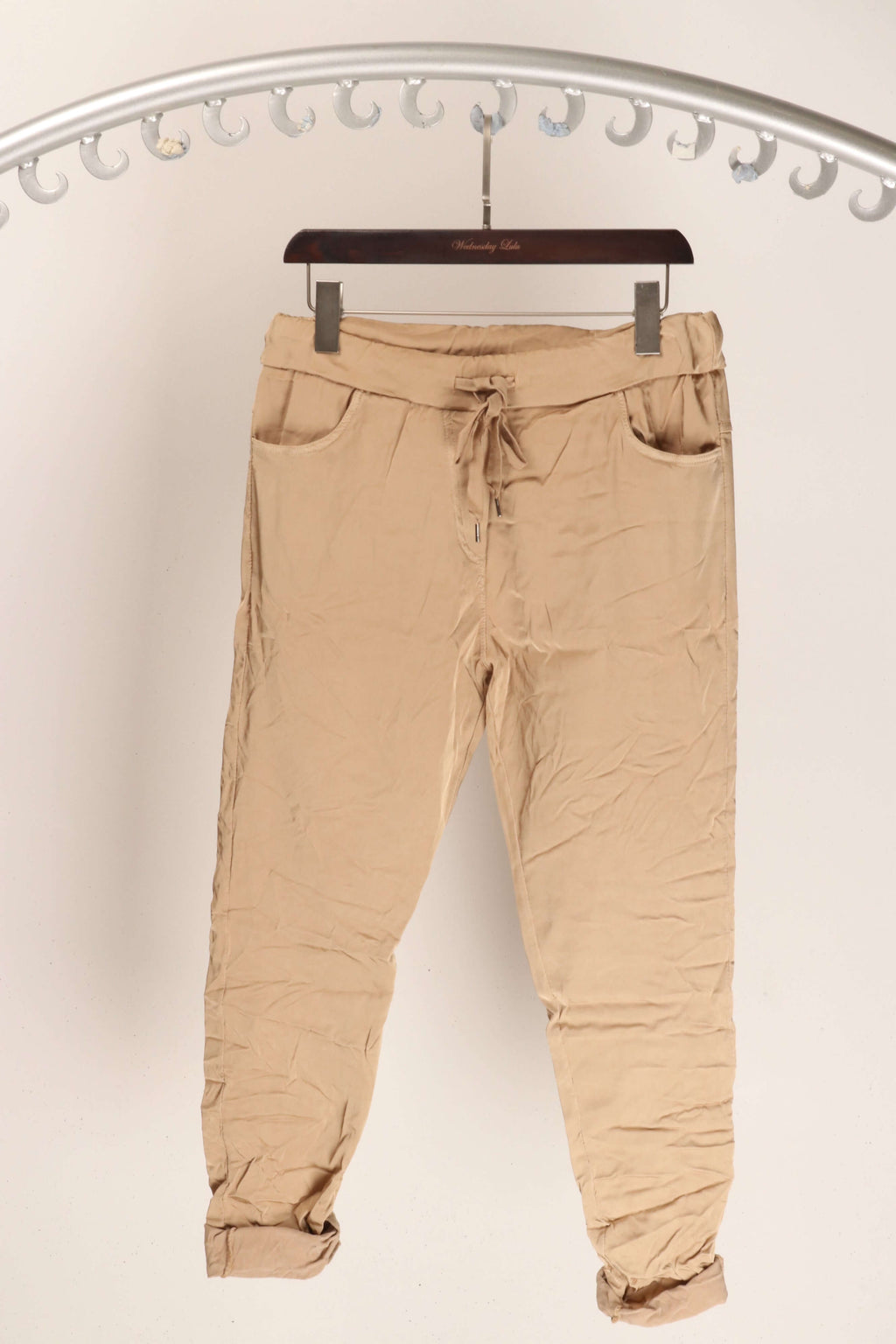 Stylish WL Shiny Crinkled Pant hanging on a display, showcasing its unique crinkled texture and premium fabric.