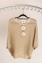 WL Daisy Back Top showcasing daisy-inspired back detail and premium fabric on a hanger.