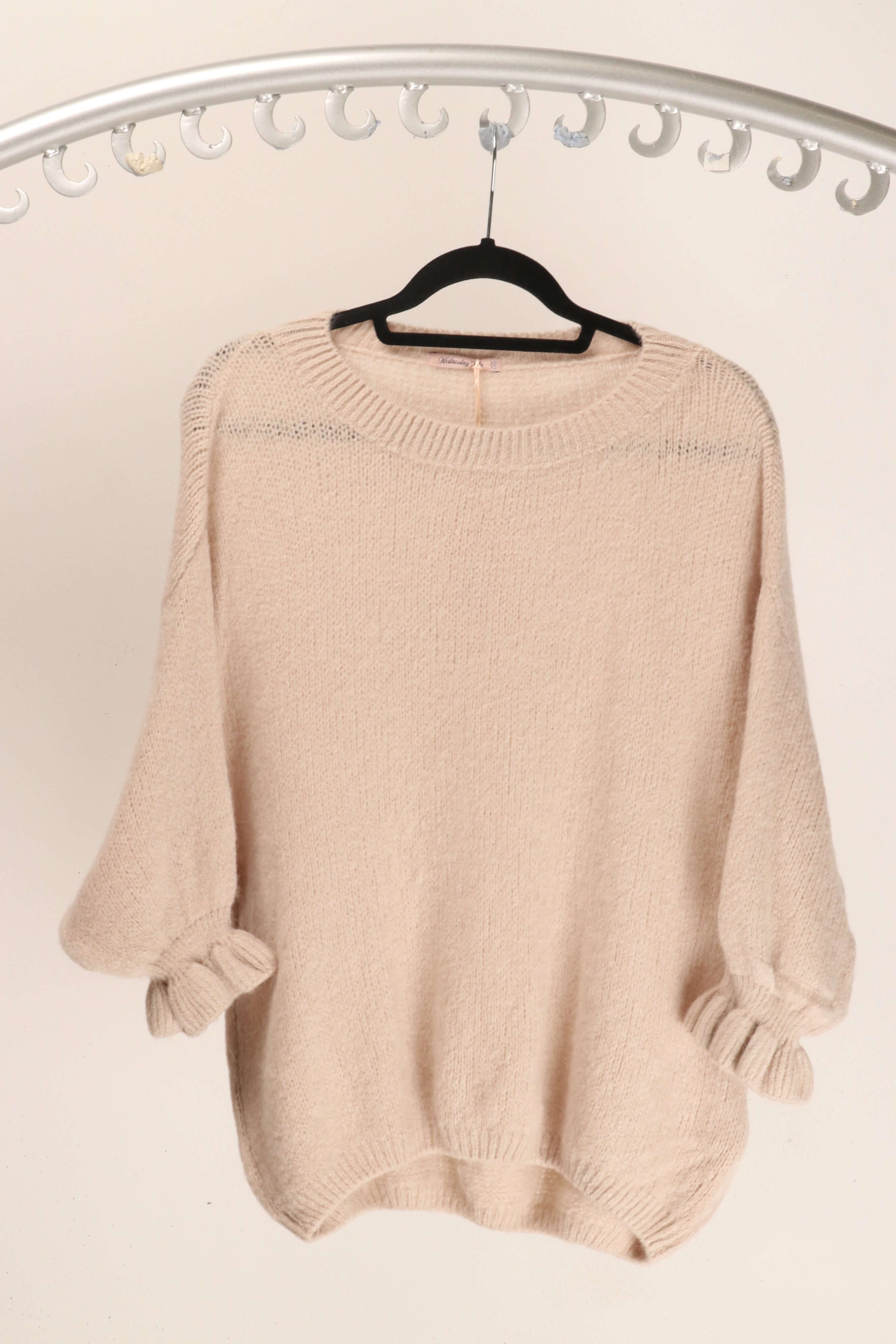 WL Fiorella Jumper on a hanger, showcasing luxurious alpaca blend fabric and feminine frill cuffs.