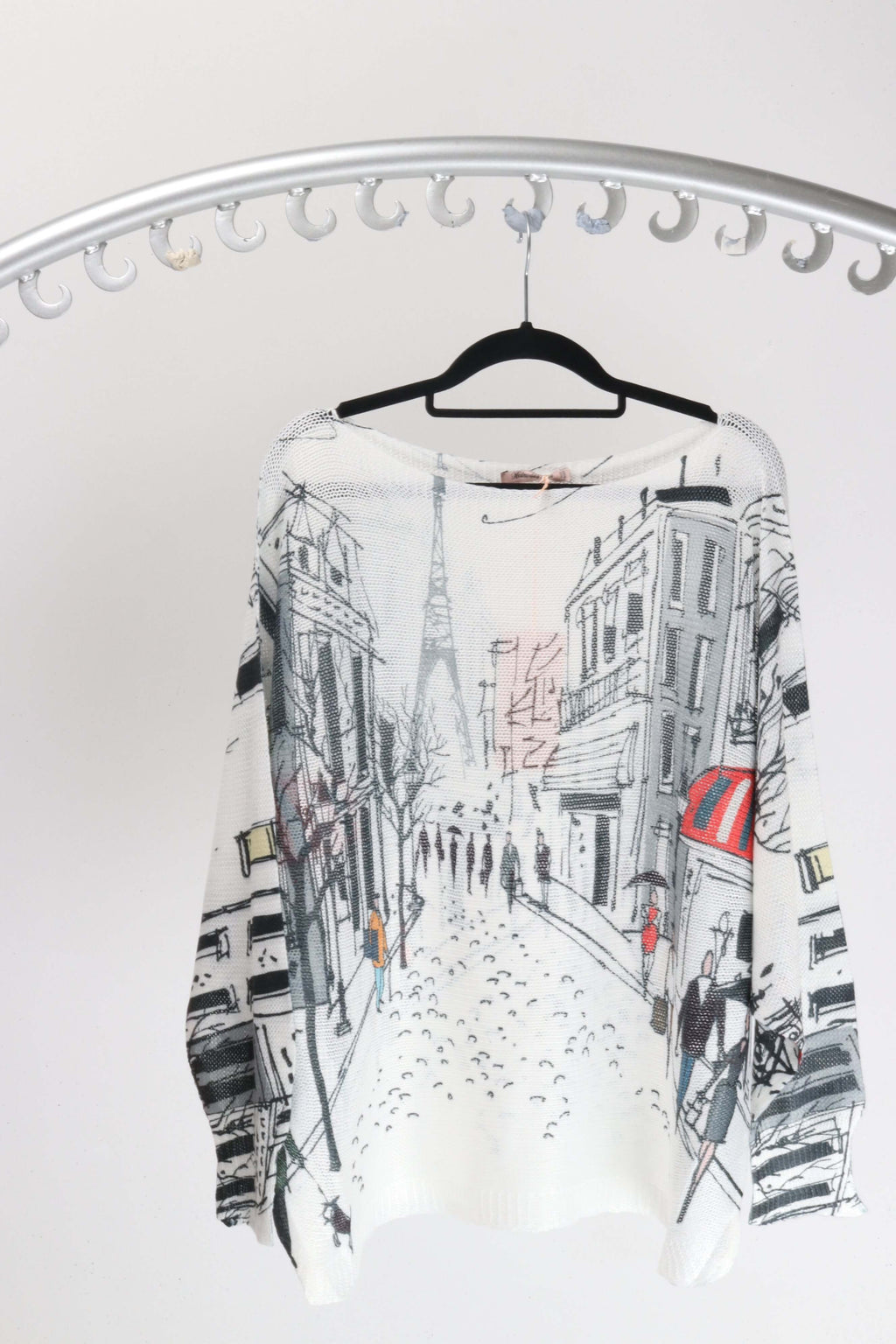 Rosa Jojo Paris street scene Knit displaying a Paris street scene design with a boat neck and bat wing sleeves.