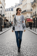 Paris street scene with a woman wearing a knit top, walking on a cobblestone street in a stylish urban setting.