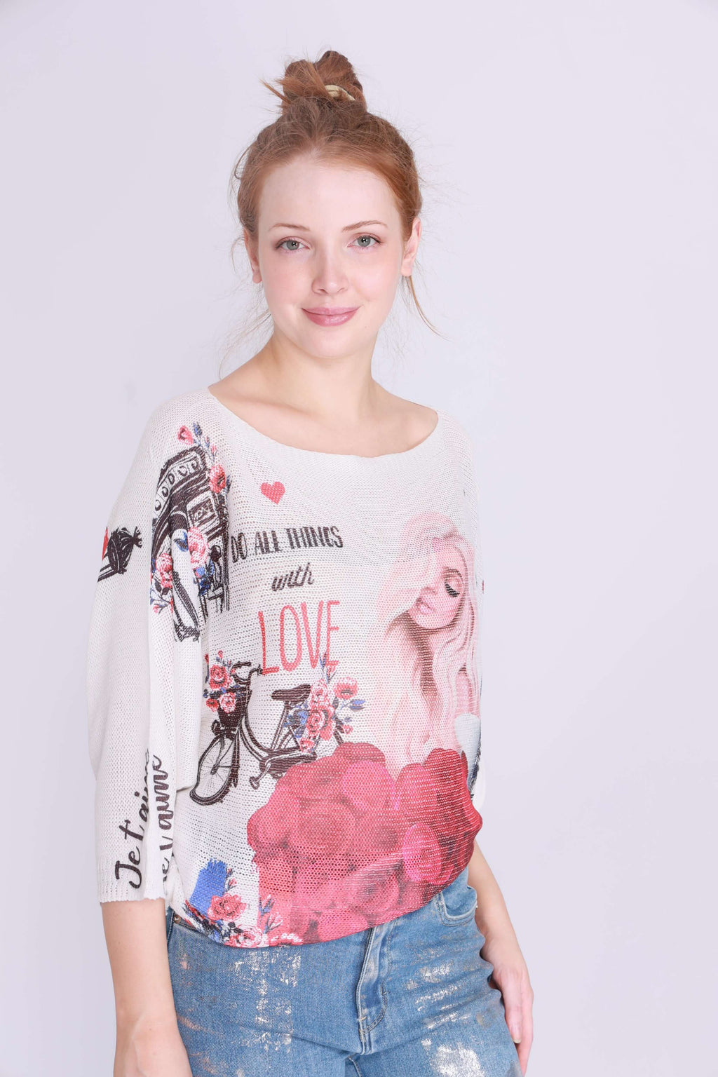 Model wearing Je taime Paris Knit, a lightweight boat neck sweater with vibrant prints and long bat wing sleeves.