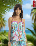 Model wearing the Orientique Marina Cami in a tropical setting, showcasing its vibrant design and summer style.