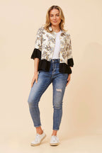 Woman wearing a stylish Jaipur Shirt with a refined collar, paired with jeans and sneakers, showcasing contemporary elegance.