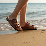 Jirona Sandals Brandy on the beach, perfect for relaxed strolls and stylish outings.