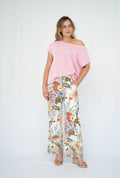 Model wearing a stylish Crepe yarn knit top with floral pants, showcasing relaxed elegance and playful flair.