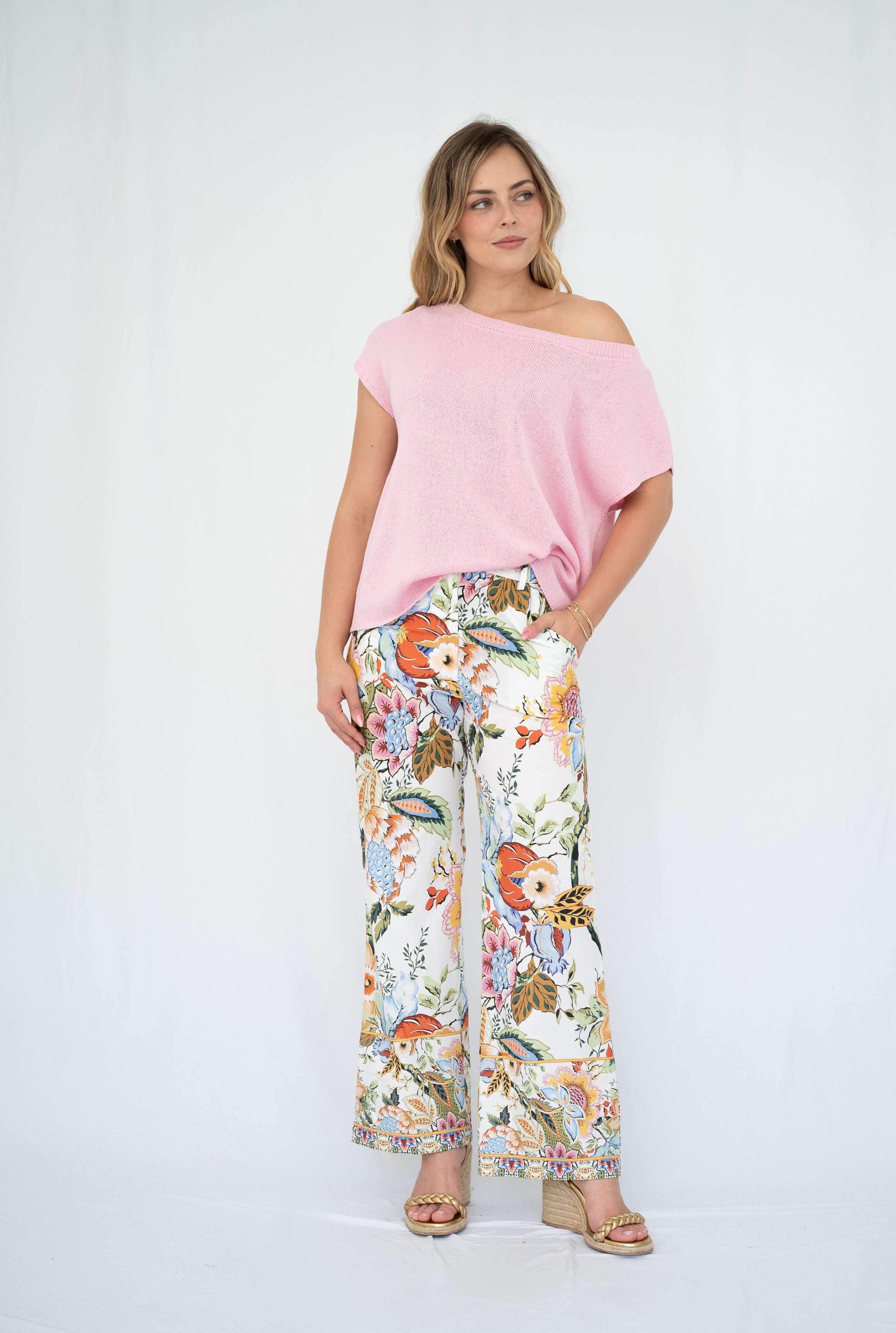 Model wearing crepe yarn knit top with floral pants for a chic, relaxed look.
