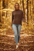 Model wearing the Katya High neck jumper in a serene autumn forest setting.