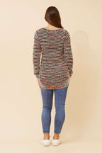 Woman wearing the Sunniva Multi Knit jumper, showcasing the back view with colorful striped design.