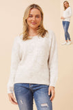 Model wearing the Erica Applique Knit in soft oatmeal with floral appliqué details.