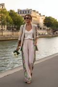 Model wearing Nina Pants with wide legs and elastic waist, styled with a blazer by the river.
