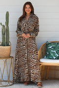 Model wearing a Leopard Maxi Shirt Dress with a relaxed silhouette and pockets, surrounded by greenery.