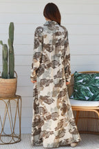 Woman wearing a Paisley Maxi Shirt Dress with long sleeves and a flowy silhouette, showcasing a chic back view.