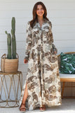 Model wearing a Paisley Maxi Shirt Dress with a relaxed fit and side splits, showcasing a bold paisley print.