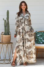 Model wearing a Paisley Maxi Shirt Dress with a relaxed fit and side splits, showcasing a bold paisley print.