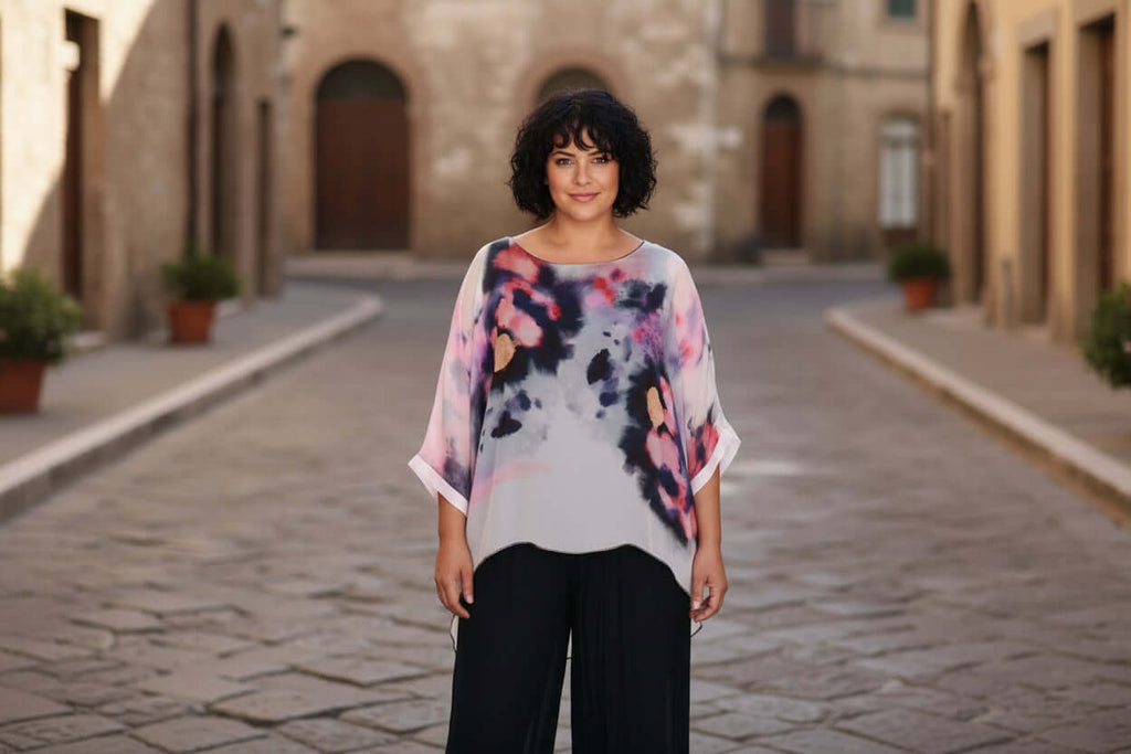 Model wearing the Lovisa Silk Top, showcasing its elegant design and beautiful colors in a charming street setting.