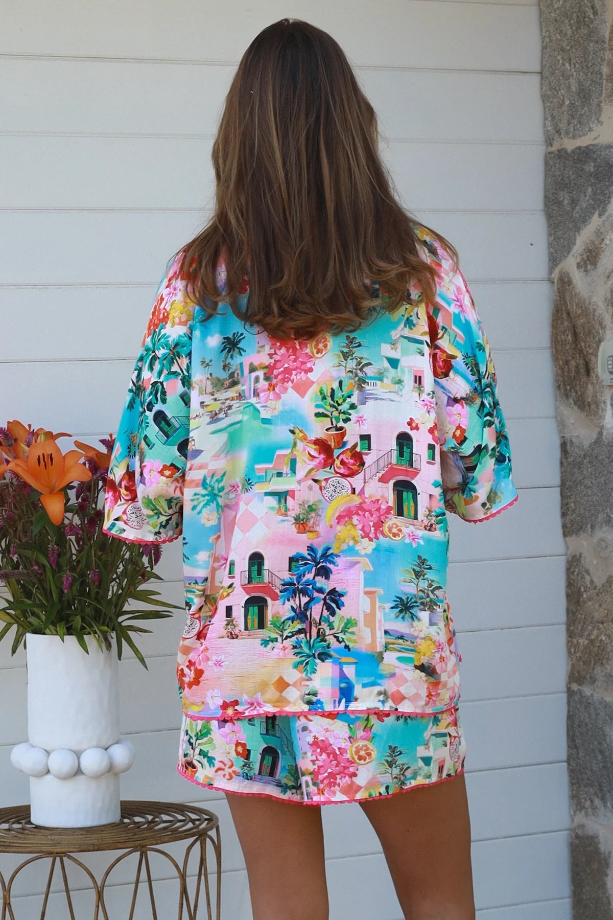 Aslin Shorts worn with a bright tropical print top, showcasing effortless comfort and stylish design.