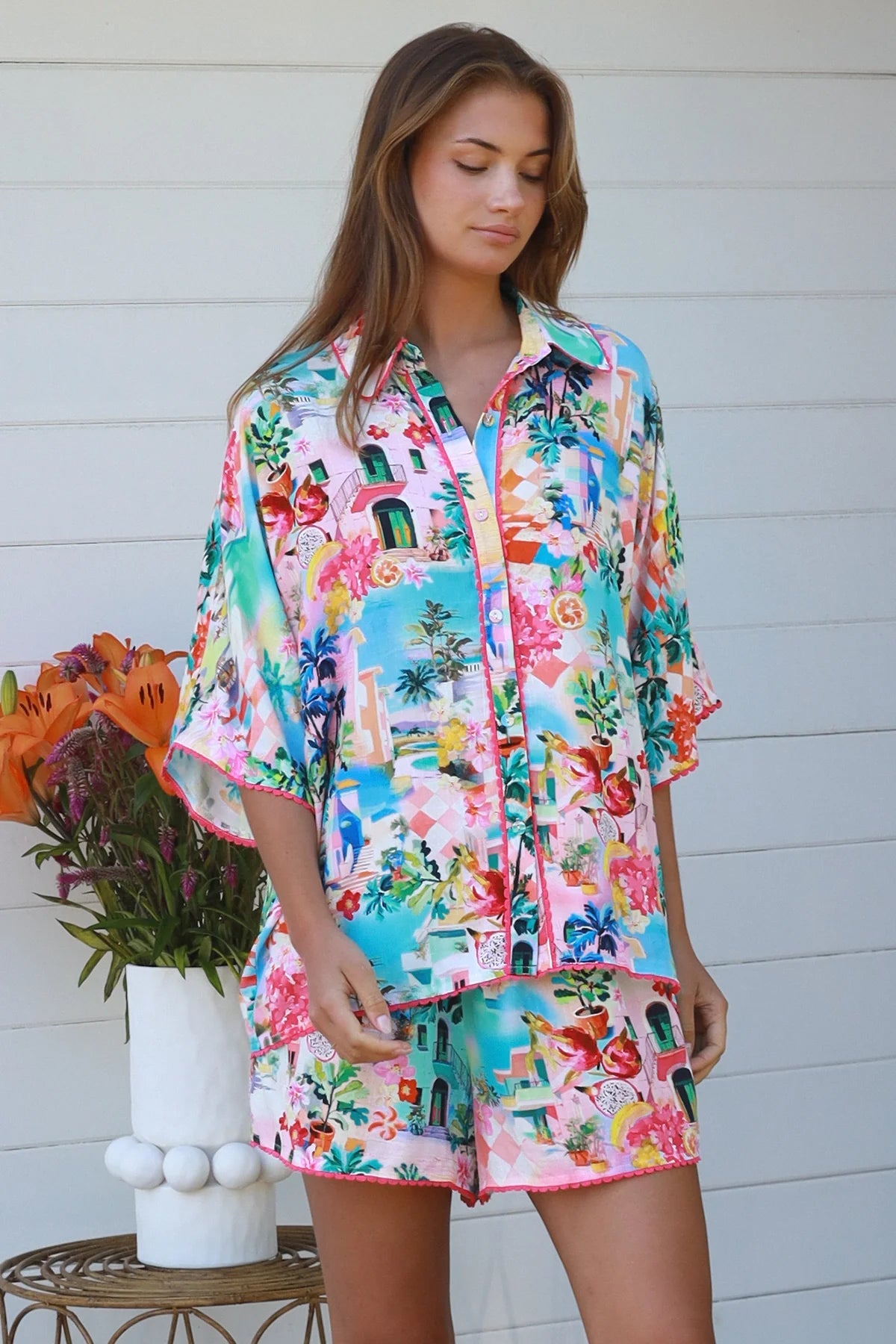 Woman wearing Aslin Shorts with a matching colorful shirt, showcasing effortless comfort and stylish design.