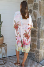 Isabella Shirt Dress featuring a tropical print with palm trees, perfect for warm-weather occasions.