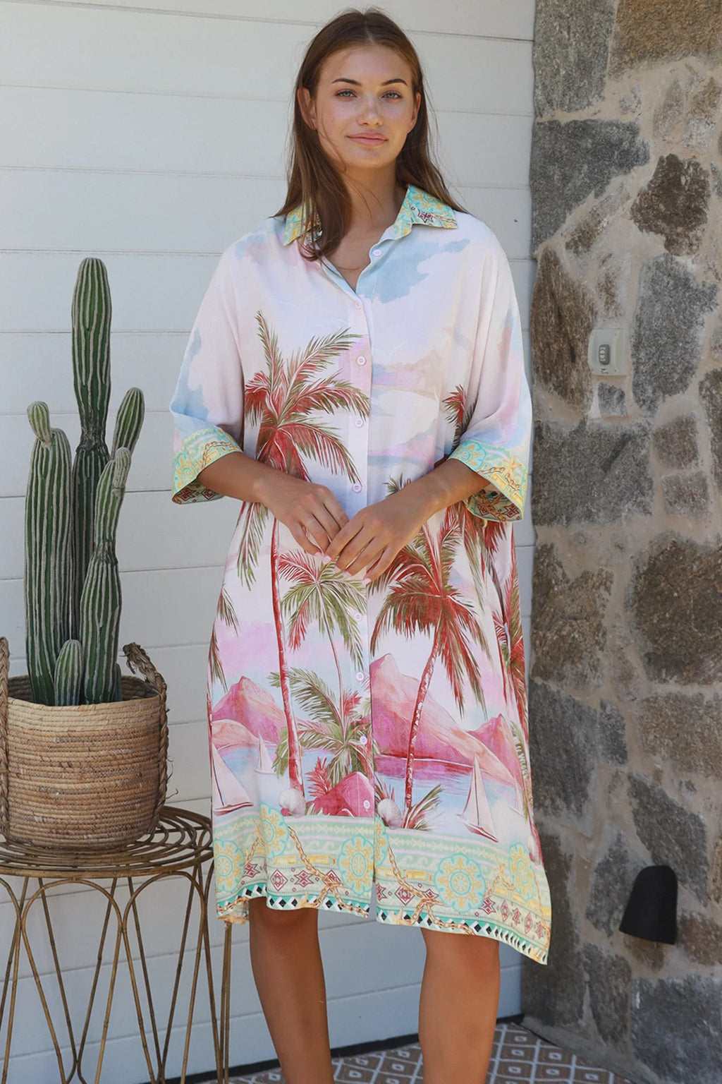 Model wearing the Isabella Shirt Dress with palm tree print, showcasing a relaxed coastal style perfect for warm weather.