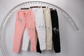 WL Palm pants collection showcasing pink, white, beige, and black styles with a crinkled look and palm designs.