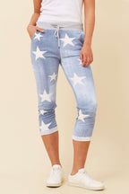 CKM 7/8 Star Jogger Pants featuring a light denim color with white star print and adjustable waistband