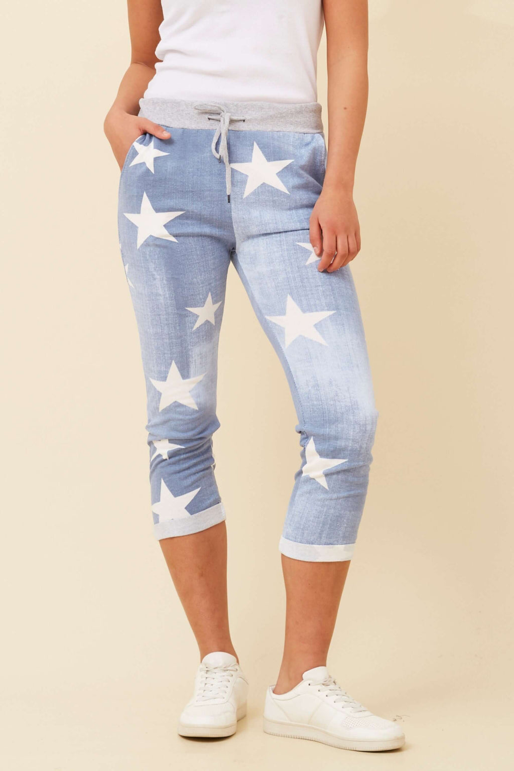 CKM 7/8 Star Jogger Pants in light denim with white star print, featuring a 7/8 length and elastic waistband.