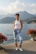 Model wearing CKM 7/8 Star Jogger Pants by Bottega Moda by the lake with mountains in the background.