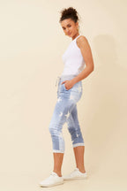 Model wearing CKM 7/8 Star Jogger Pants in light denim with star print, showcasing a modern look and comfortable fit.
