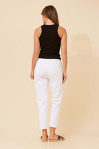 Woman in black tank top and white Ivana Crop Pants, showcasing a casual yet chic look from the back.