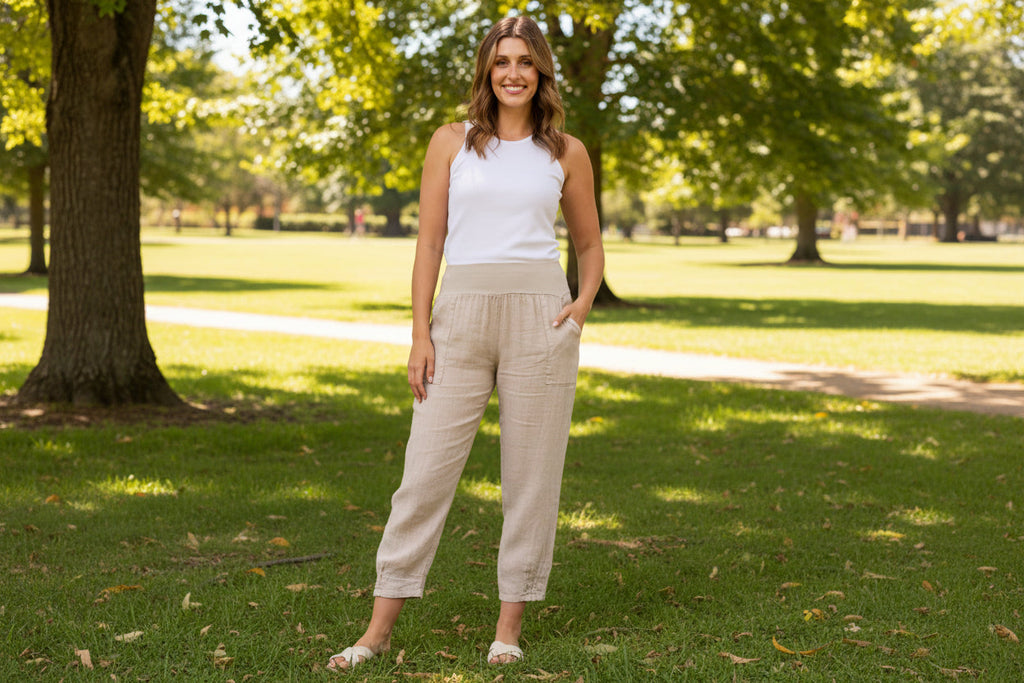 Model wearing Roma Linen Pants in a park, showcasing Italian craftsmanship and stylish wide leg design.