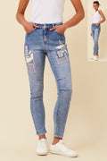 Stylish model wearing Patch Jeans with front and back pockets, denim fabric, and adjustable waistband.