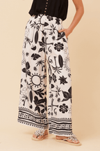 Bahama Pants featuring a cream base with bold black print and wide leg silhouette for effortless resort style.