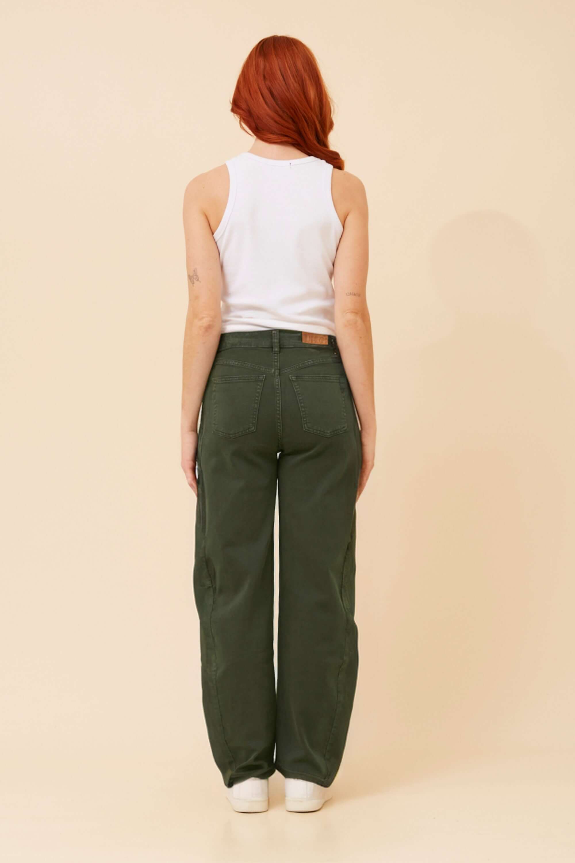 Model showcasing the Annika Barrel Jean in khaki, featuring a barrel leg silhouette and modern curved shape from the back.