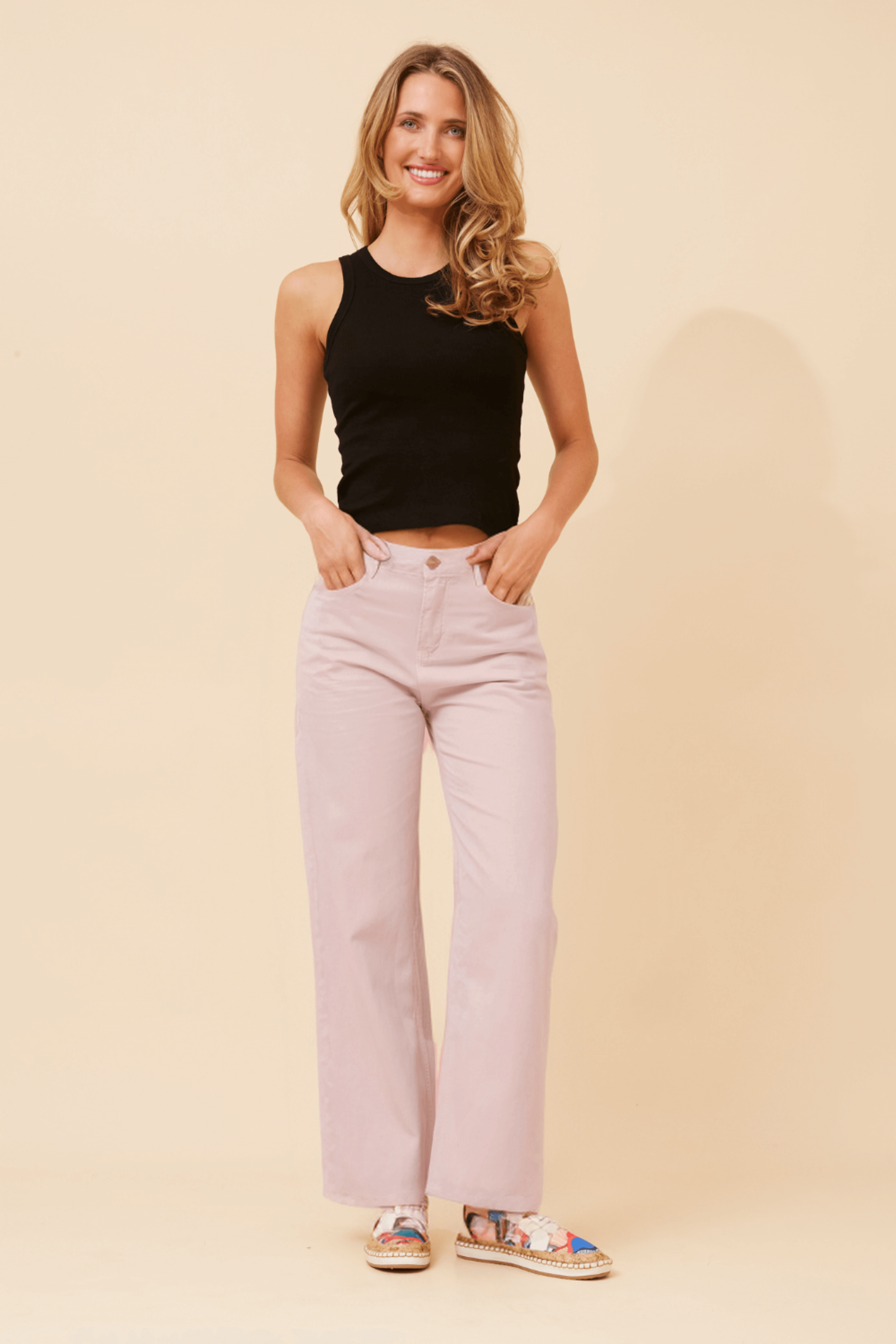 Ronja Wide leg Jeans shown in a stylish outfit with a black tank top and patterned shoes on a light background.