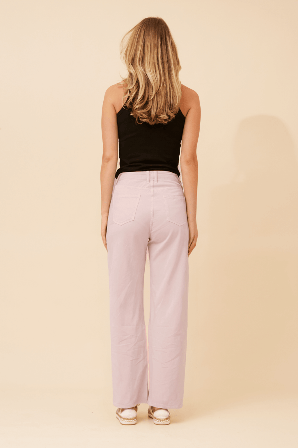 Woman wearing Ronja Wide Leg Jeans, view from back, highlighting the relaxed fit and nougat shade.
