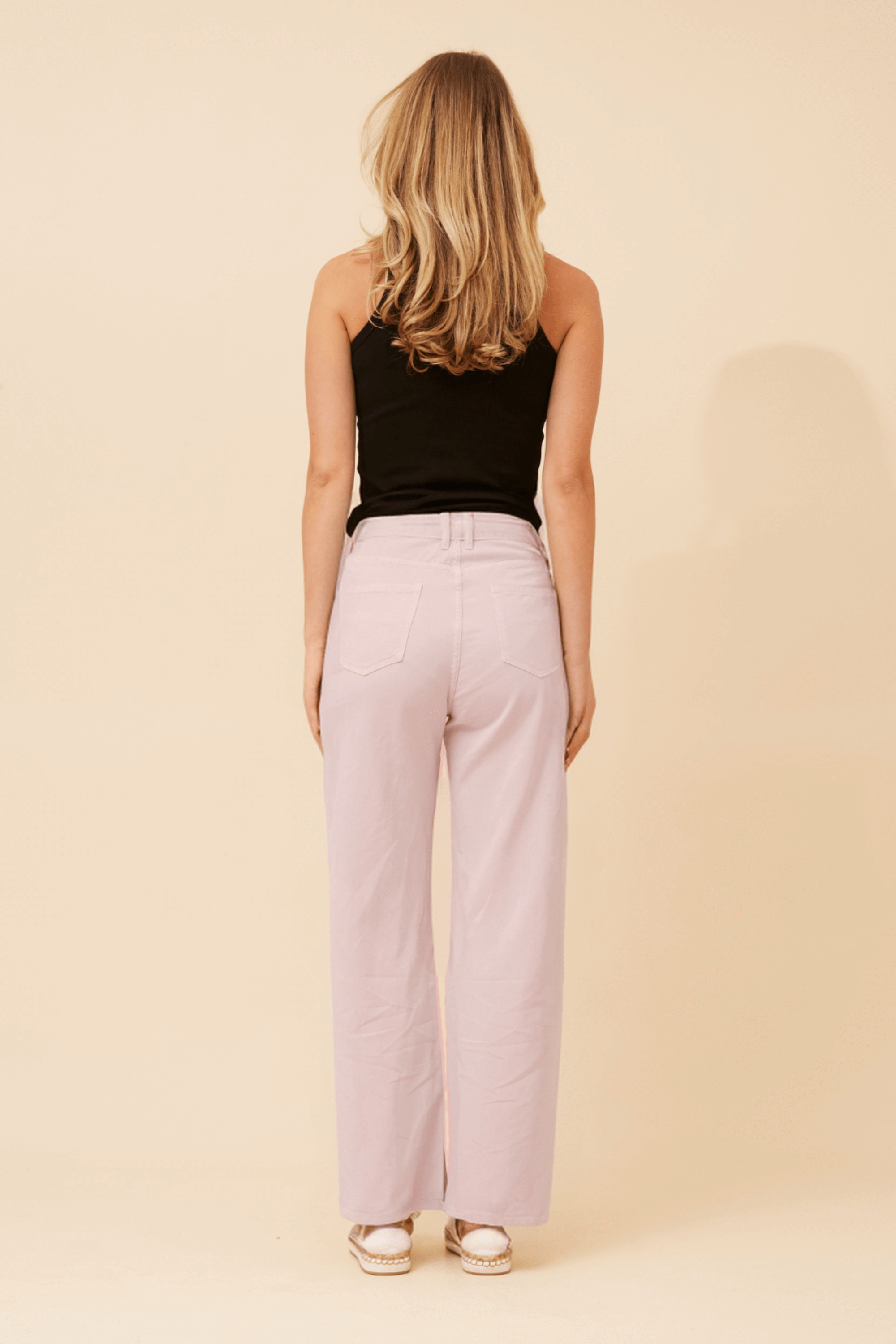 Woman wearing Ronja Wide Leg Jeans, view from back, highlighting the relaxed fit and nougat shade.