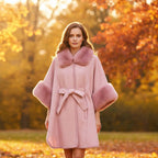 Anya Cape with luxurious faux fur trim and collar in a picturesque autumn setting.