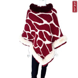 Rock Poncho in red and white giraffe print with faux fur trim, perfect for stylish warmth.