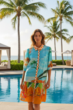 Lydia Collar Dress featuring a vibrant tropical design, perfect for sunny days by the pool.