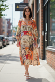 Sri Palm 3 button Dress worn by a model outdoors, showcasing vibrant floral patterns and relaxed elegance.