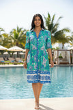 Carolina Shirt dress NU modeled by a woman by the pool, showcasing its breezy design and playful puff sleeves.