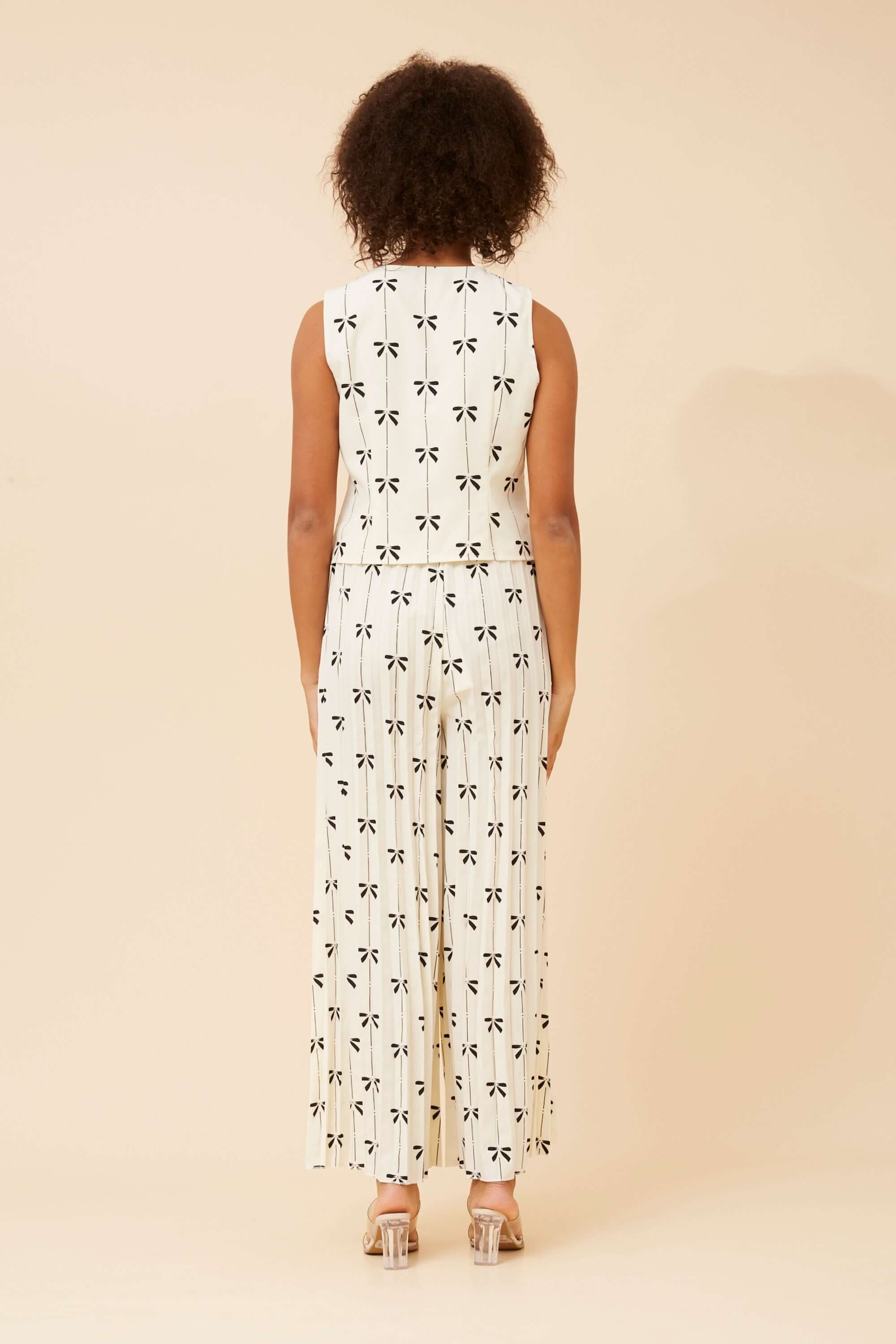 Back view of the Maja Bows Pant Set featuring a sleeveless top and wide leg pleated pants with a playful bow print.