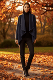 Model wearing WL Zita Coat in a fall setting, showcasing its elegant open-front design and stylish layering.