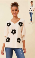 Daisy Pullover featuring a V neck, batwing sleeves, and a raised daisy pattern in ivory color.