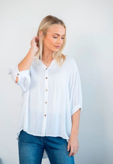 Model wearing QQ Bishop Blouse white, showcasing its mandarin collar and button details against a light backdrop.
