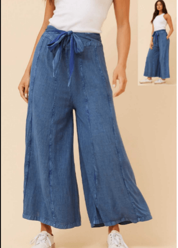 CKM Flared pant in dark denim showcasing effortless elegance and comfort for the modern woman.