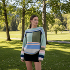 Model wearing Maja Multi Jumper against a snowy mountain backdrop, showcasing its vibrant colors and relaxed fit.